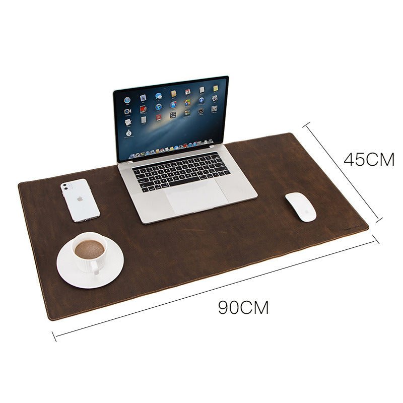 Stylish leather oversized non-slip mouse/pad work station with laptop, coffee, and phone for an organized workspace.