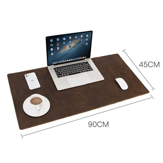 Stylish leather oversized non-slip mouse/pad work station with laptop, coffee, and phone for an organized workspace.