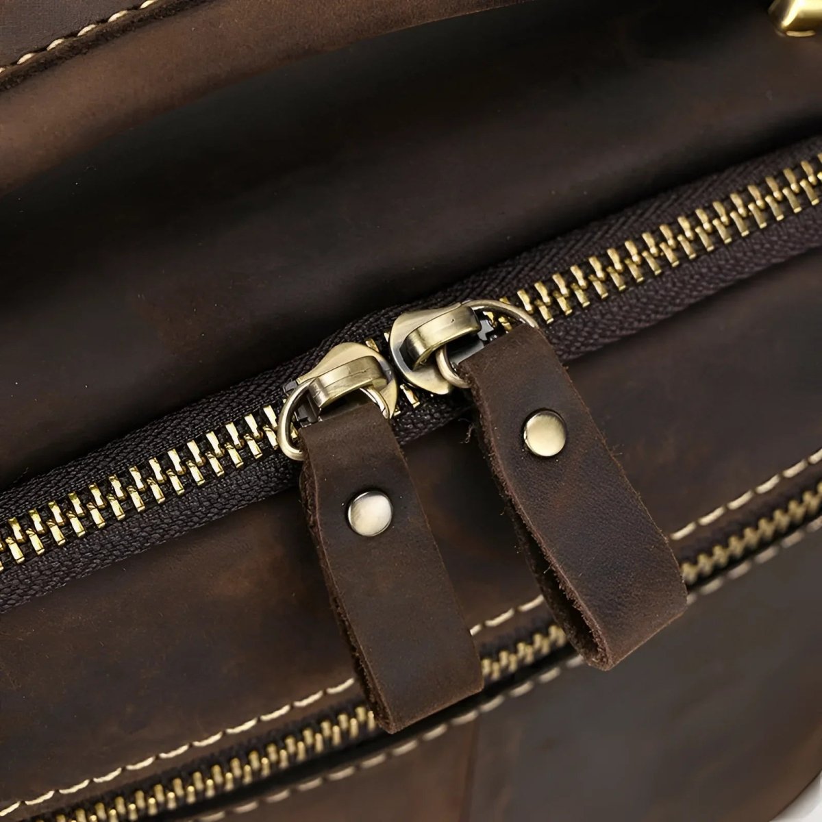 Detailed close-up of The tablet satchel's robust zipper and leather features, showcasing quality craftsmanship.
