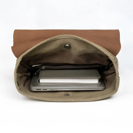 Vintage leather/canvas backpack interior with pockets for laptop and notebook, showcasing a stylish and functional design.