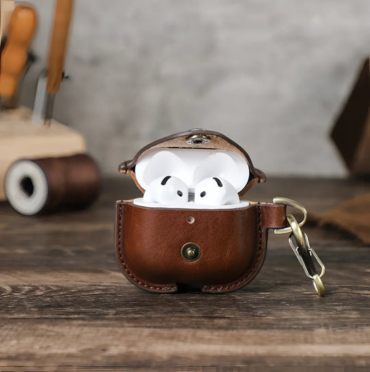 Stylish Airpods 4 leather case in brown, showcasing earbuds inside, perfect for protection and style.