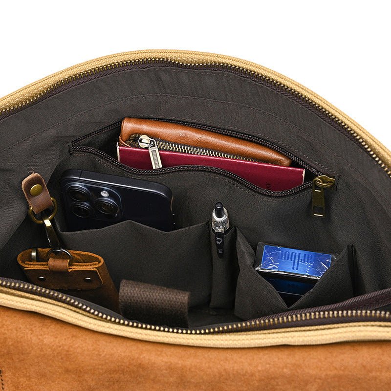 Inside view of the Men's vintage canvas and leather messenger bag, showcasing organized compartments for essentials.