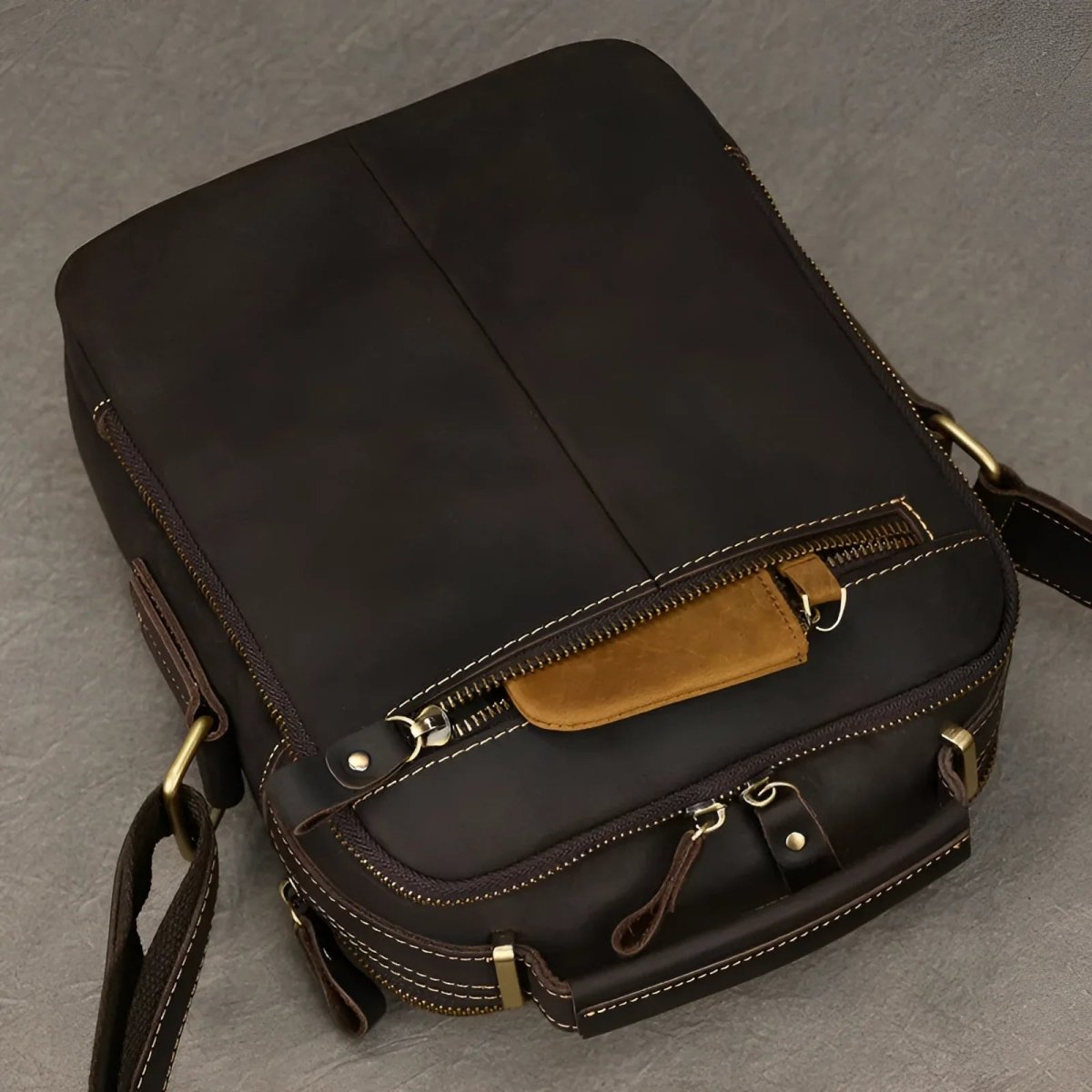 The tablet satchel features a sleek design with premium leather and practical zip pockets for stylish organization.