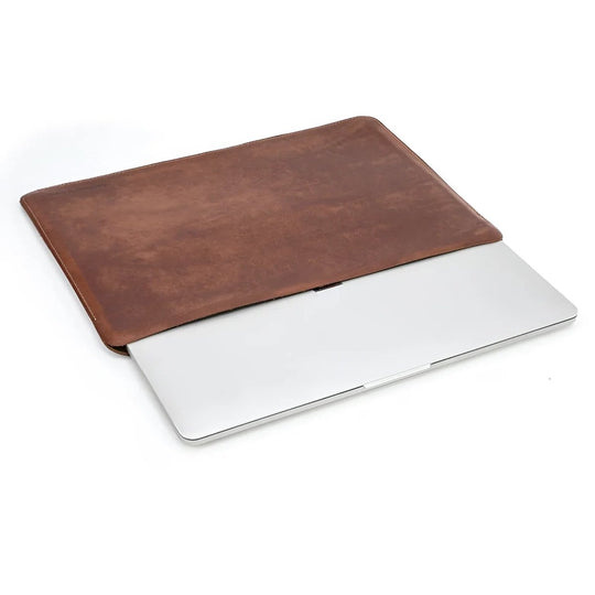 Stylish genuine leather sleeve 13" protecting a laptop, showcasing quality craftsmanship and durability.